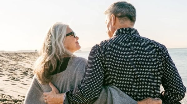Older couple hugging on beach